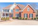 Charming two-story home featuring a mix of brick, neutral siding and well-maintained landscaping at 408 Hickory Fairway Ct, Woodstock, GA 30188