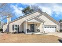 Charming single-Gathering home features a well-maintained front yard and inviting entrance with covered porch at 6 Alicia Ct, Marietta, GA 30062
