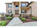 Inviting front facade with stately columns, brick exterior, and beautifully landscaped entrance at 641 Freeman Brock Rd, Auburn, GA 30011