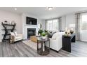 Cozy living room with fireplace, modern furnishings, stylish decor, and large windows for plenty of natural light at 2715 Stream Valley Lane Nw Nw Cir, Atlanta, GA 30318