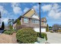 Charming townhome exterior with stone accents, two garages, and a landscaped yard at 805 Pleasant Hill Nw Rd # 343, Lilburn, GA 30047