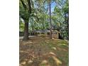 Lovely single-story home with a long driveway surrounded by mature trees and lush greenery, exuding serene charm at 2681 Aquamist Dr, Decatur, GA 30034