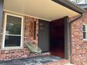Modern front entrance with unique address numbers, designer chair, and brick facade at 3504 Palace Ct, Tucker, GA 30084