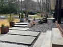 Concrete steps leading up to the porch of a brick home with manicured rock garden at 3504 Palace Ct, Tucker, GA 30084