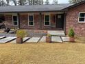Inviting brick front porch with concrete pathway and decorative potted plants at 3504 Palace Ct, Tucker, GA 30084