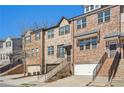 View of the brick townhomes showcasing their architectural details and landscaping at 109 Bridlington St, Sugar Hill, GA 30518