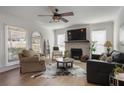 Cozy living room with fireplace, hardwood floors, and ample natural light from large windows at 2083 Fairhaven Ne Cir, Atlanta, GA 30305