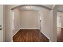 Open-concept entryway featuring archways, hardwood floors, and abundant natural light at 441 Concord Cir, Mcdonough, GA 30253