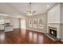 Open-concept living space with fireplace and hardwood floors connected to the kitchen at 441 Concord Cir, Mcdonough, GA 30253