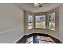 Bright breakfast nook featuring a bay window offering scenic views and hardwood flooring at 45 Kirkland Ct, Covington, GA 30016