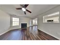 Inviting living room featuring a cozy fireplace, hardwood floors, and natural light at 45 Kirkland Ct, Covington, GA 30016