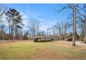 Ranch style home on sprawling lot surrounded by mature trees at 1256 Highway 142 E, Covington, GA 30014