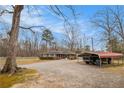 Exterior view of home with gravel driveway and convenient carport at 1256 Highway 142 E, Covington, GA 30014