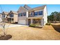 Attractive two-story home with brick, stone, two car garage, and a green front yard, showcasing a welcoming curb appeal at 555 Birkdale Dr, Fairburn, GA 30213