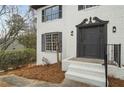 Close-up view of the home's entrance with a stylish front door, and manicured landscaping at 1936 Oak Ridge Ct, Marietta, GA 30062