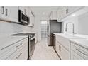 Bright kitchen features white cabinets, stainless appliances, and a white farmhouse sink at 213 Tuxworth Cir, Decatur, GA 30033