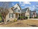 View of the brick home's facade showcasing the front yard, covered entrance, and well-maintained landscaping at 3262 Emerald Brook Ln, Decatur, GA 30033