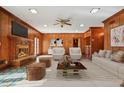 Spacious living room with wood walls, cozy fireplace, plush seating, and stylish decor for relaxation at 5110 Jett Forest Trl, Atlanta, GA 30327