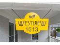 Close-up of a custom yellow Westview address sign hung at 1613 at 1613 Westwood Sw Ave, Atlanta, GA 30310