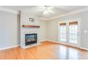 Bright living room with white-brick fireplace, wood mantel, and access to an outdoor deck at 215 Aldridge Pl # 9, Smyrna, GA 30082