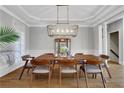 Elegant dining room with hardwood floors and modern lighting fixture at 3493 Maryhill Nw Ln, Kennesaw, GA 30152