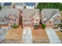 Aerial view of a suburban neighborhood showcasing a well-maintained home with a driveway and nearby houses at 2479 Brynfield Cv, Suwanee, GA 30024