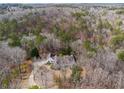 Aerial view showcasing the home nestled among lush, mature trees at 5515 Punkintown Rd, Douglasville, GA 30135