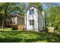 An angle view of this white two story home highlighting the fence line and backyard at 2453 Paul Nw Ave, Atlanta, GA 30318