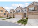 Charming townhome exteriors with attached garages and well kept landscaping at 5975 Vista Brook Dr, Suwanee, GA 30024