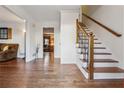 Elegant foyer features hardwood floors and a staircase with decorative iron railings at 1061 Steeple Run, Lawrenceville, GA 30043