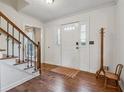 Bright foyer with hardwood floors and a white front door with sidelights at 1061 Steeple Run, Lawrenceville, GA 30043
