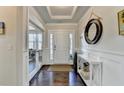 Inviting foyer with hardwood floors, elegant console table, decorative mirror, and recessed lighting at 1431 Torrington Dr, Hoschton, GA 30011