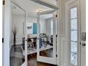 Bright office space with glass french doors, hardwood floors, and view of a front yard at 1431 Torrington Dr, Hoschton, GA 30011