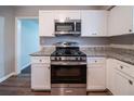 Bright kitchen with white cabinets, granite counters, and stainless steel appliances at 1770 Lynn Ln, Decatur, GA 30032