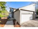 Home exterior featuring an attached two-car garage, board siding, and a walkway at 10 Colony Ridge Dr, Alpharetta, GA 30022