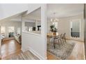 Open-concept living and dining room with hardwood floors and natural light at 10 Colony Ridge Dr, Alpharetta, GA 30022