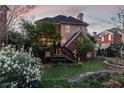 Charming backyard featuring a deck, lush lawn, and beautiful landscaping, creating a serene outdoor space at 1029 Fairway Ne Ests, Atlanta, GA 30319