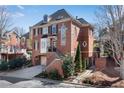 Brick home featuring a two-car garage, landscaped front yard, and traditional architectural details at 1029 Fairway Ne Ests, Atlanta, GA 30319