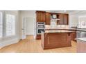 Gourmet kitchen features an island, stainless steel appliances, and custom cabinetry at 1029 Fairway Ne Ests, Atlanta, GA 30319