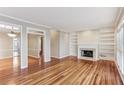 Bright living room with fireplace, built-in shelving and gleaming hardwood floors at 2515 Oak Quarters, Smyrna, GA 30080