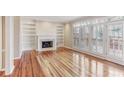 Bright living room with a fireplace, built-in bookshelves, hardwood floors and access to a patio at 2515 Oak Quarters, Smyrna, GA 30080