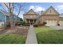 Inviting brick home boasting a well-maintained lawn, trimmed bushes, and a paved walkway to the front door at 4620 Westgate Dr, Cumming, GA 30040