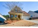 Traditional home featuring a manicured lawn, charming front porch, and inviting curb appeal at 422 Windy Ridge Way, Canton, GA 30114