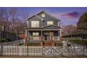 Charming two-story home featuring a welcoming front porch and white picket fence, perfect for curb appeal at 65 Vannoy Se St, Atlanta, GA 30317