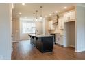 Kitchen with an island, stainless steel appliances, hardwood floors, and bright lighting at 4826 Floydwood Ln, Mableton, GA 30126