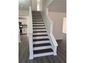 Elegant staircase with dark wood treads and white risers in a bright, modern interior at 5055 Promenade Sw Dr, Atlanta, GA 30331