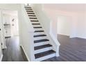 Elegant staircase with dark wood treads and white risers leading to a bright, modern interior at 5055 Promenade Sw Dr, Atlanta, GA 30331