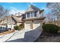 Inviting townhome featuring a two-car garage, brick accents, and neutral siding at 5729 Evadale Trce # 6, Mableton, GA 30126