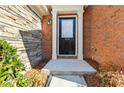 Close-up of the front door with brick and stone accents, providing a welcoming entrance at 5729 Evadale Trce # 6, Mableton, GA 30126