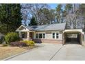 A cozy, one-story home boasts a covered carport and attractive landscaping, providing a welcoming curb appeal at 2592 Valley Stream Dr, Atlanta, GA 30360